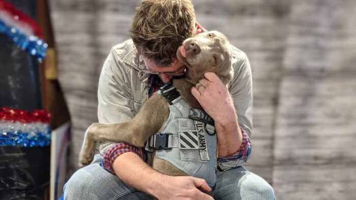 Army Veteran hugging his dog